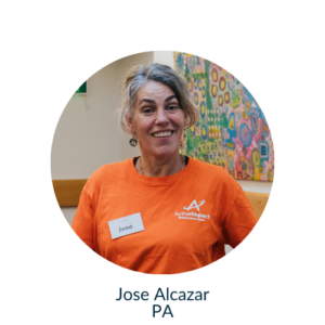 Jose wearing an Active Impact orange tshirt, looking at the camera, beaming